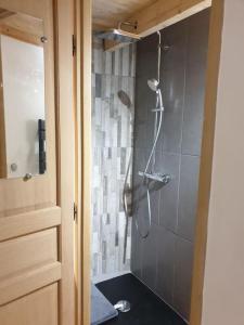 a bathroom with a shower with a shower head at Tour de charme atypique in Beauregard-lʼÉvêque