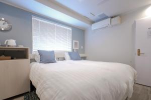 Rúm í herbergi á Asakusa Designer Hotel YOSHII