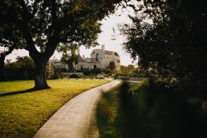 a walkway in front of a large building at Ottolire Resort in Locorotondo