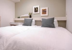 Rúm í herbergi á Asakusa Designer Hotel YOSHII