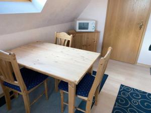una mesa de madera y sillas en una habitación en Appartement Möhlkiek en Nordstrand