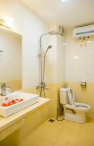 a bathroom with a sink and a toilet at Aloha Hotel in Hanoi