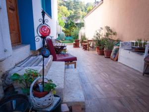 a patio with benches and potted plants on a building at Mákvirág Apartmanok in Zebegény