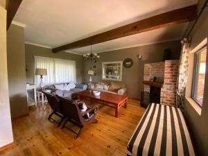 a living room with a couch and a table at Umzimkulu River Lodge in Underberg