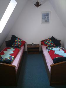 two beds sitting next to each other in a room at Noclegi Hexe in Żegocina