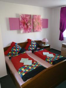 a bedroom with a large bed with colorful pillows at Noclegi Hexe in Żegocina