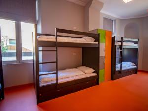 two bunk beds in a room with a window at BANANA'S CAMP in Cannes