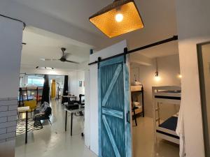 a room with a blue door and a dining room at IM Santai Lodge in Kangar +62 photos