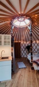 a room with a yurt with a bed in it at Jurta Jutra in Węglówka