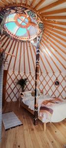 a bedroom with a bed in a yurt at Jurta Jutra in Węglówka
