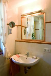 a bathroom with a sink and a mirror at Ferienwohnung Kaiserin in Reit im Winkl
