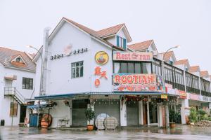 ein Gebäude mit einem Restaurant in einer regnerischen Straße in der Unterkunft The Concept Hotel Langkawi in Kuah