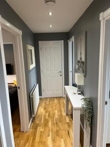 a room with a white desk and a white door at Flat Three, 212 Eaglesham Road, East Kilbride, Glasgow in East Kilbride