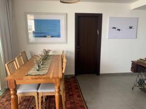 a dining room with a wooden table and chairs at Sea of Galilee Tiberius apartment with panoramic sea view in Tiberias