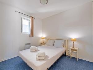 a bedroom with a white bed and a window at Vacancéole - Le Domaine de Bertheaume in Plougonvelin +56 photos