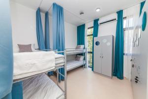 a hospital room with two bunk beds and a window at HOSTEL BIGOVA in Kotor
