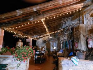 a living room with lights hanging from the ceiling at Agriturismo Podere Tegline in Radda in Chianti