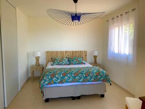 a bedroom with a large bed and a chandelier at Villa U Tramontu in Granace