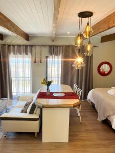 a bedroom with a table and a bed and a couch at Eagleview Guesthouse in Hermanus