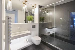a bathroom with a toilet and a glass shower at Host & Stay - Oxford House in Harrogate
