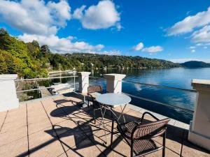 a balcony with a table and chairs and a view of the water at boat house facing the lake in Orta San Giulio