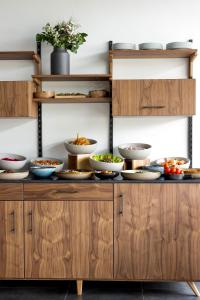 a buffet with bowls of food on it at New Hotel of Marseille - Vieux Port in Marseille