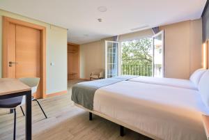 Postel nebo postele na pokoji v ubytování Smart Hotel La Sagra