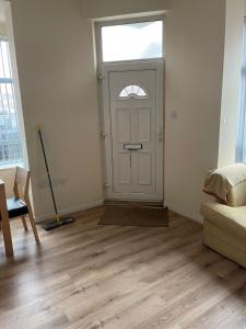 a room with a door with a window and a mop at 1 Bedroom Flat - Milligan Road Leicester in Leicester