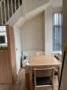 a dining room with a wooden table and chairs at 1 Bedroom Flat - Milligan Road Leicester in Leicester