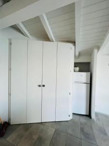 a group of white cabinets in a room at boat house facing the lake in Orta San Giulio