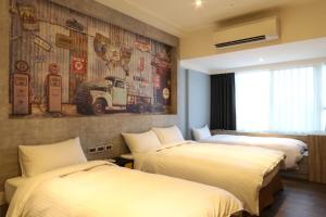 a hotel room with two beds and a mural at MU House in Taipei