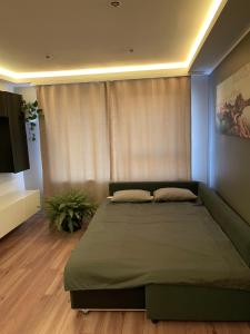 a bedroom with a large bed and a couch at Jūras iela 21 in Limbaži