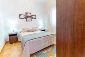 a small bedroom with a bed and two night stands at El Pajero de Floreal in Mazo