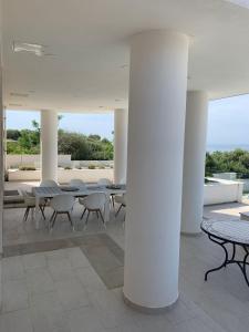 a group of tables and chairs in a building at Resort Villa Moses in Novalja