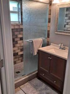 a bathroom with a shower and a sink at Beautiful, quiet & cozy home near Lake Worth Beach in Lake Worth