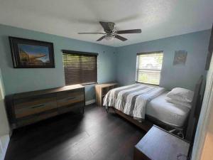 a bedroom with a bed and a ceiling fan at Beautiful, quiet & cozy home near Lake Worth Beach in Lake Worth