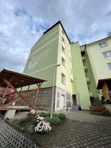 a building with a bench and flowers in front of it at Penzion Greenstar in Ústí nad Labem