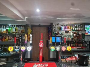 a bar with a lot of bottles of alcohol at The Crown Hotel in Inverbervie