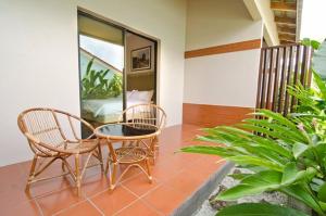 a room with two chairs and a table and some plants at MyDream Guest House in Ipoh