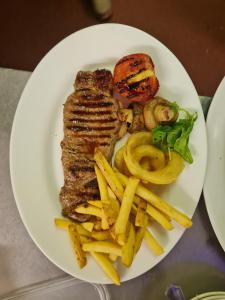 a plate of food with french fries and meat at The Crown Hotel in Inverbervie