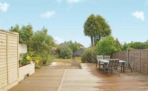 a patio with a table and chairs on a wooden deck at Oak in Whetstone