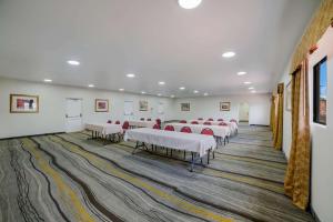 a room with rows of tables and chairs in it at Quality Inn & Suites Goodyear - Phoenix West in Goodyear