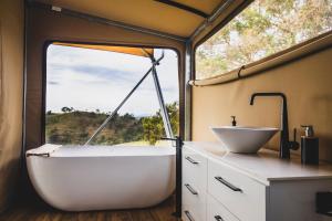 a bathroom with a tub and a sink at Sierra Escape Luxury Glamping in Piambong +24 photos