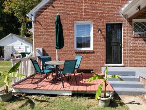 une terrasse avec une table, des chaises et un parasol dans l'établissement Magnolias, à Richmond