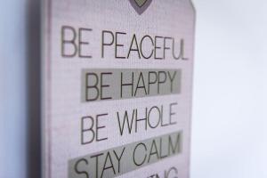 a sign that says be peaceful be happy stay whole at City Home from Home - Peaceful, Cosy & Modern 2Bed house in Nottingham