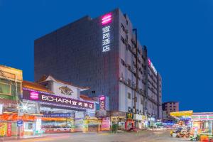 a tall building with a sign on the side of it at Echarm Hotel Foshan Guangfo Road Jiaokou Metro Station in Foshan