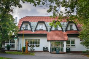 een wit gebouw met een rood dak bij Hotel Na Skalkách in Nový Jičín