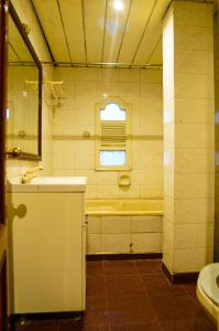 a bathroom with a tub and a sink at HOTEL PLAZA GRAND in Jalandhar