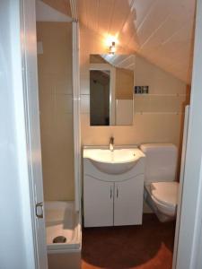 a small bathroom with a sink and a toilet at Ferienhaus Turilji in Albinen