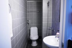 a small bathroom with a toilet and a sink at Starhostel Dongdaemun Suite in Seoul